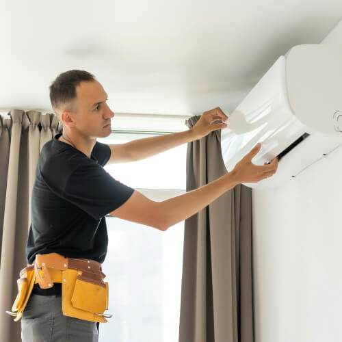 Person installing an air conditioning unit
