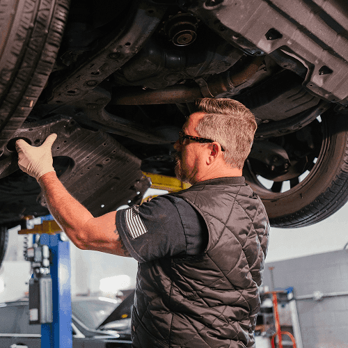 Automechanic working on a car