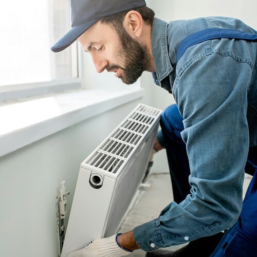 Home services professional installing a heating unit