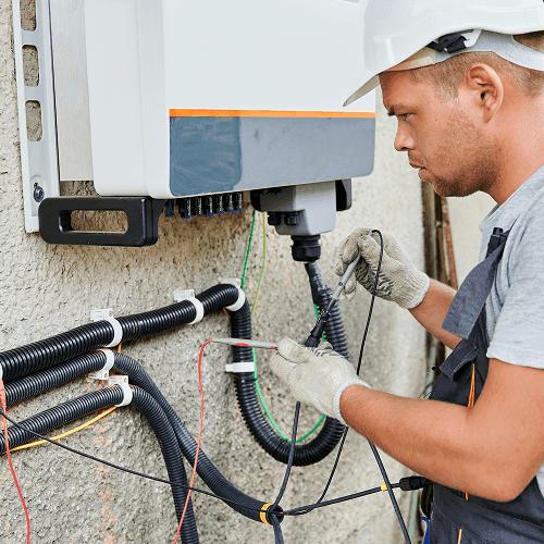 Electrician working on an outside breaker box