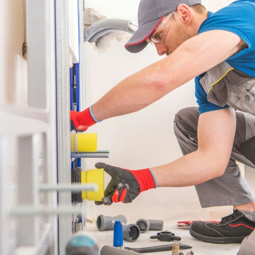 Plumber working on a pipe